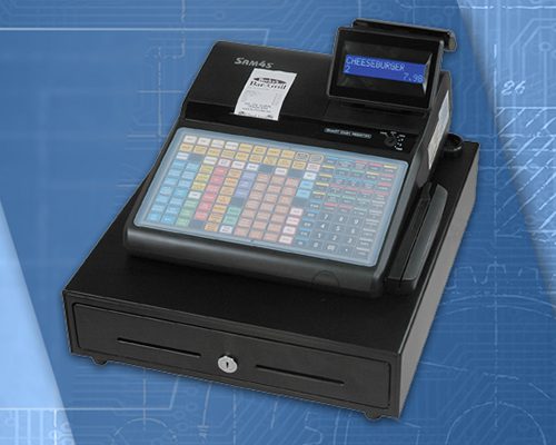 A cash register with a pen and paper on top of it.